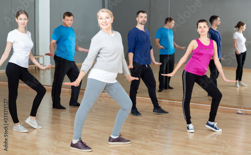 Middle-aged woman exercising at dance class