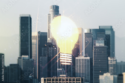 Double exposure of creative light bulb hologram on Los Angeles city skyscrapers background, research and development concept