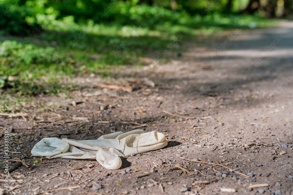Latex Glove thrown away in nature - earth pollution during pandemic crisis Latex Glove thrown away in nature - earth pollution during pandemic crisis