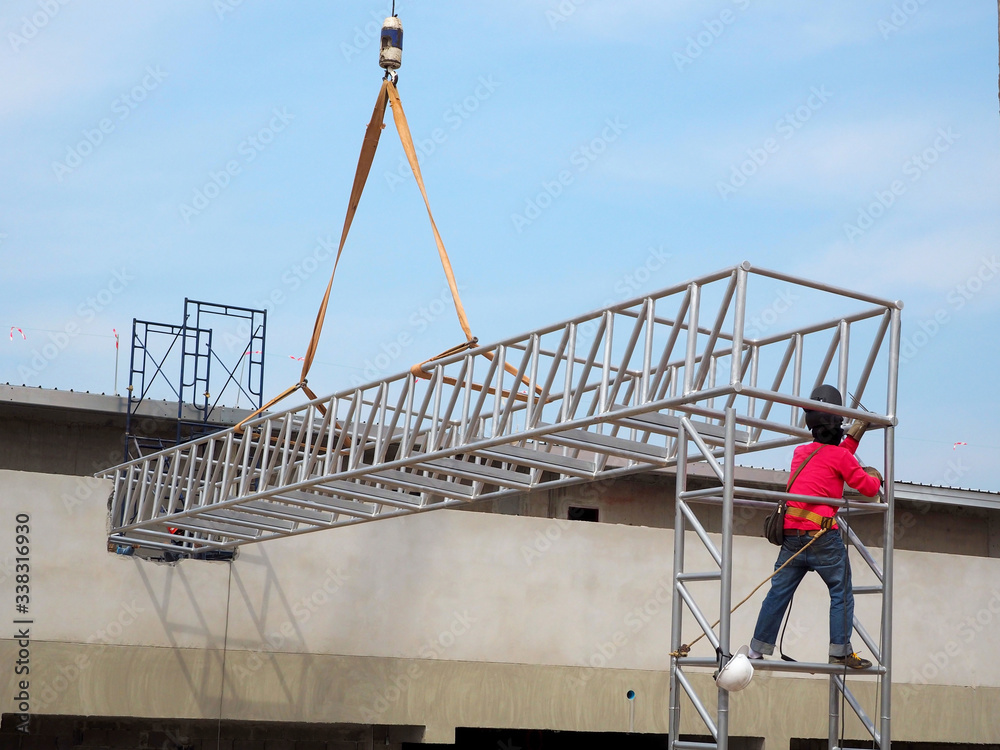 Man Working on the Working at height on construction site with blue sky