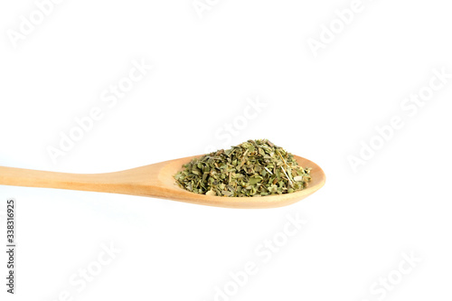 Top view oregano on wooden spoon– isolated on white background