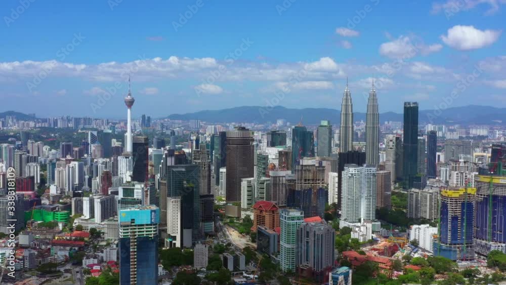 KUALA LUMPUR, MALAYSIA - FEBRUARY 28, 2020: 4K clip aerial view of Kuala Lumpur city center skyline cityscapes with blue sky. High rise buildings. KUALA LUMPUR, MALAYSIA - FEBRUARY 28, 2020: 4K clip aerial view of Kuala Lumpur city center skyline cityscapes with blue sky. High rise buildings.