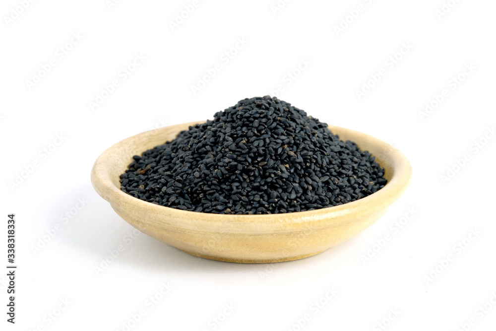 Closeup sweet basil seeds on wooden bowl – isolated on white background Closeup sweet basil seeds on wooden bowl – isolated on white background