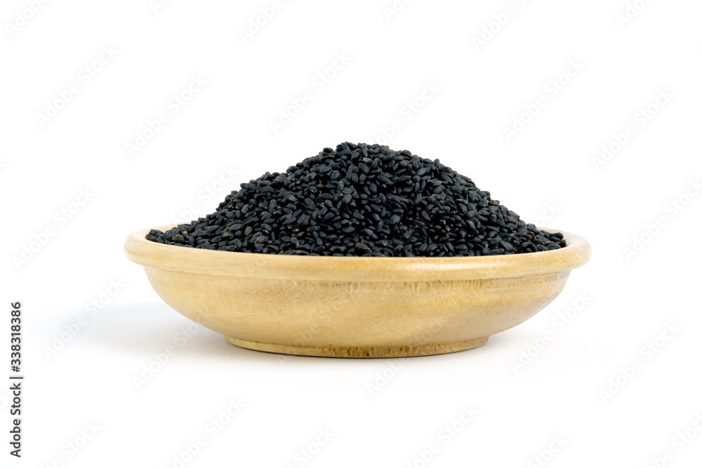 Closeup sweet basil seeds on wooden bowl – isolated on white background Closeup sweet basil seeds on wooden bowl – isolated on white background