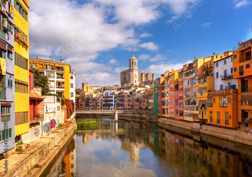 Colorful houses on the Onyar river with reflection in the water on a summer sunny day. The sights of Girona are cities in Catalonia, Spain. City landscape.
 #338318380