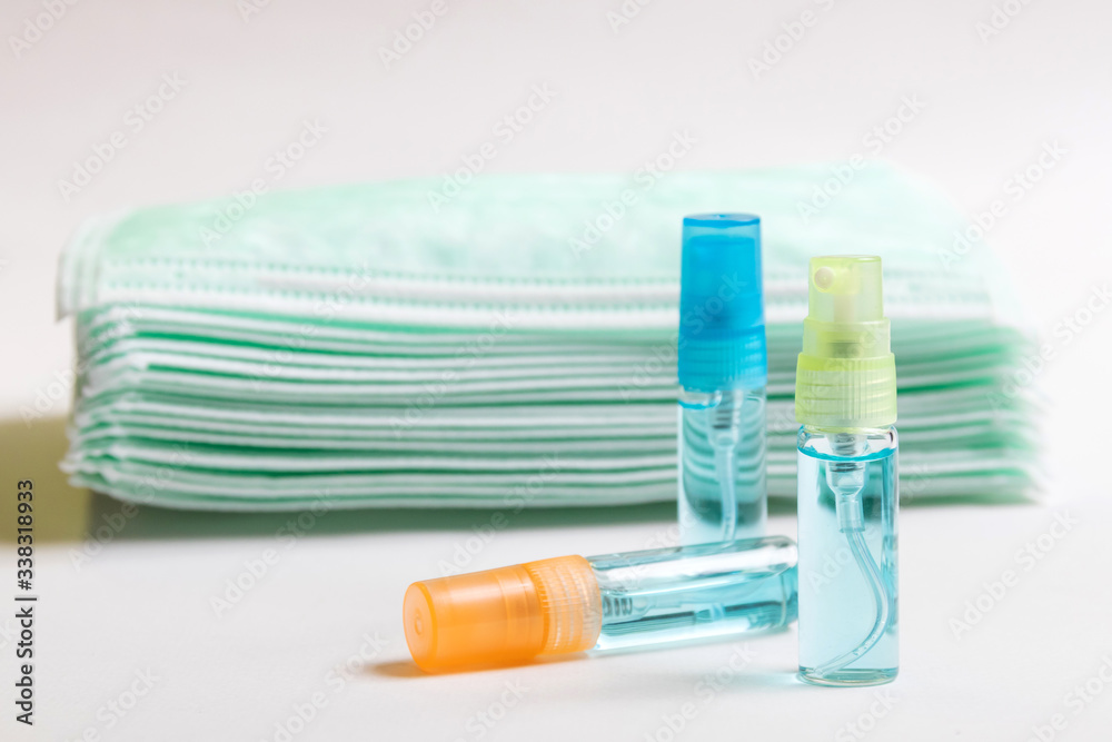 Alcohol spray and surgical mask for protect against COVID-19 Coronavirus and clear bacteria. Hygiene concept. Alcohol spray and surgical mask for protect against COVID-19 Coronavirus and clear bacteria. Hygiene concept.