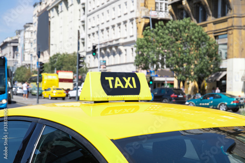 Yellow taxi car with a checker. Urban transport