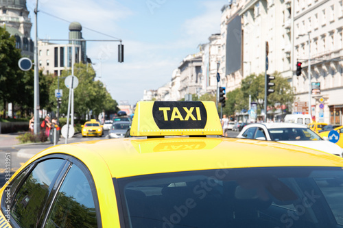 Yellow taxi car with a checker. Urban transport