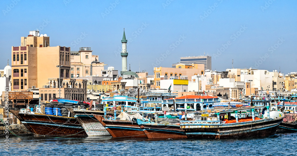 Traditional wooden Dhows moored on the creek in Dubai in the district Deira 