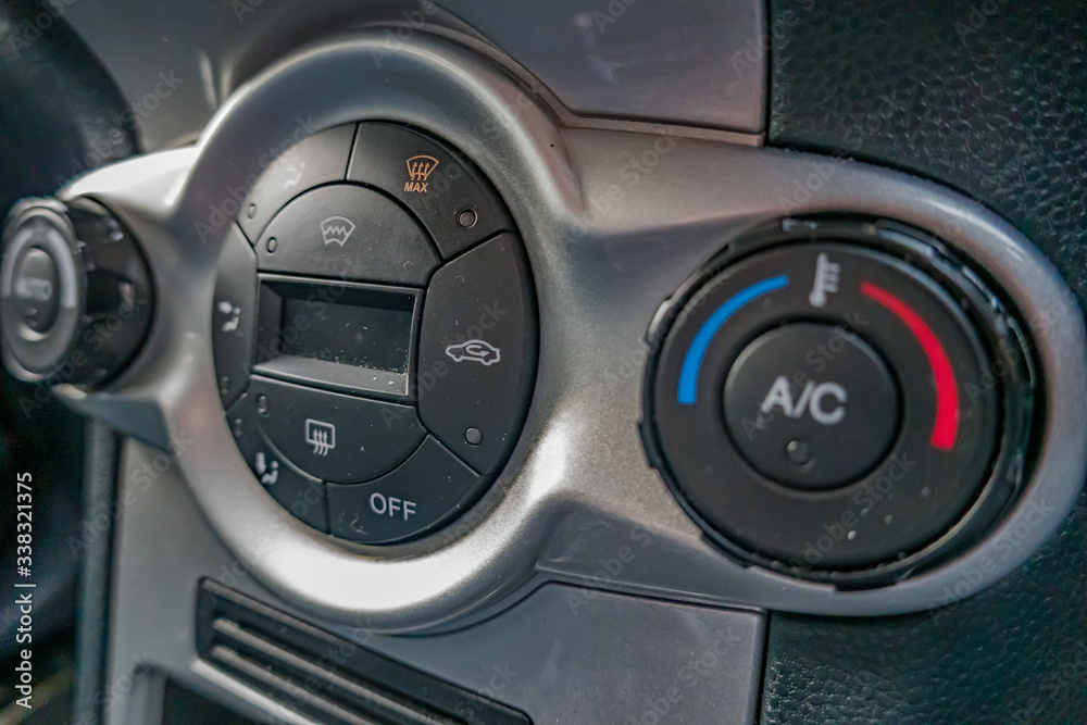 Close up and intentional selective focus of buttons and controls in hatchback car