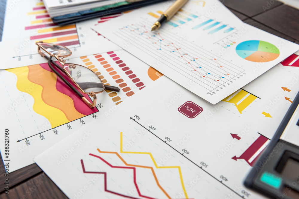 financial charts, work at paper business diagram with pen, at office. financial charts, work at paper business diagram with pen, at office.