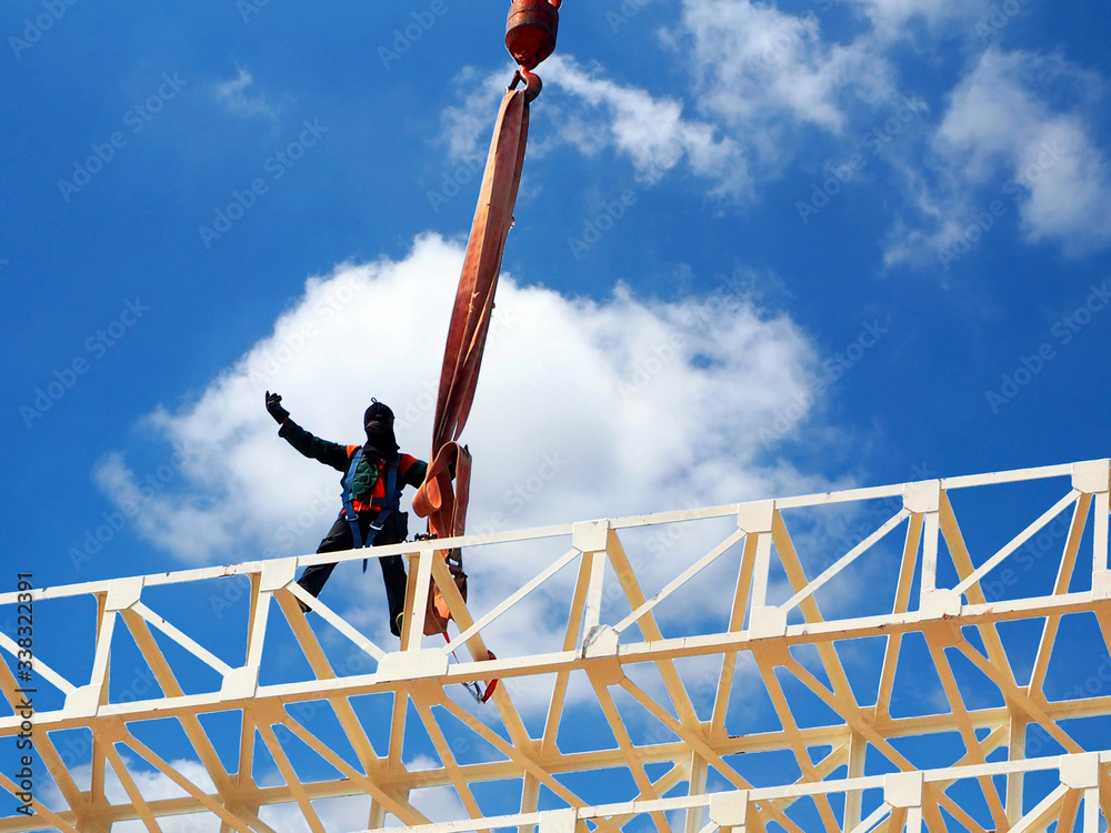 Man Working on the Working at height on construction site with blue sky