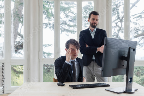 Two male executive working with computers