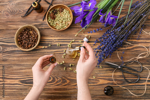 Woman preparing perfume on table, top view