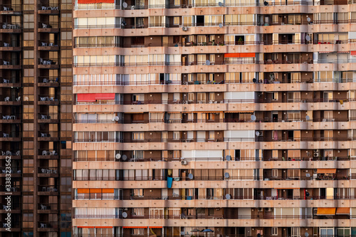 Obraz na płótnie Front view of typical apartments in Benidorm. Modern buildings at the sunset w salonie