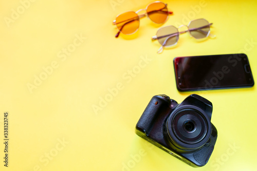 Camera, sunglasses and mobile phone