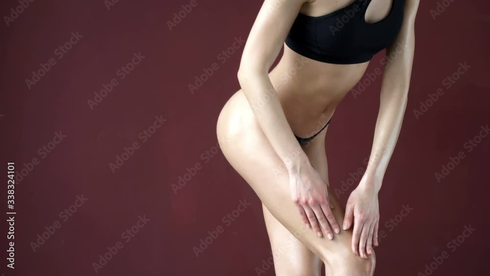 A young girl with a magnificent trained body poses against the backdrop of a purple wall. A young girl with a magnificent trained body poses against the backdrop of a purple wall.