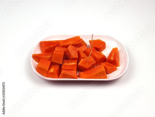 Papaya, chopped on a plate Isolated on a white background