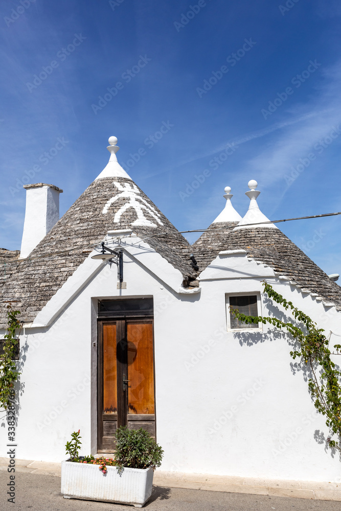 Tradtional white houses in Trulli village. Alberobello, Italy. The style of construction is specific to the Murge area of the Italian region of ApuliaMade of limestone and keystone.