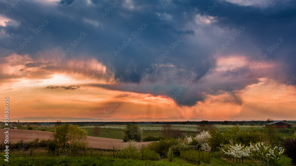 Dark sky with heavy clouds ober the Black Forest fields.