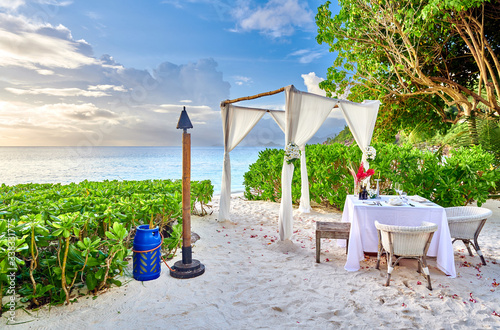 Table set up for romantic dinner on beach at Seychelles