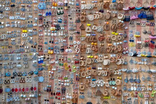 Colorful handmade earrings for sale for tourists at the street market in Hoi An old town, Vietnam