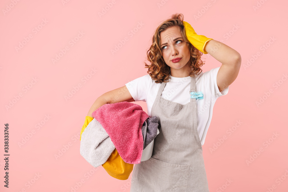 Tired young woman housewife holding laundry. Tired young woman housewife holding laundry.