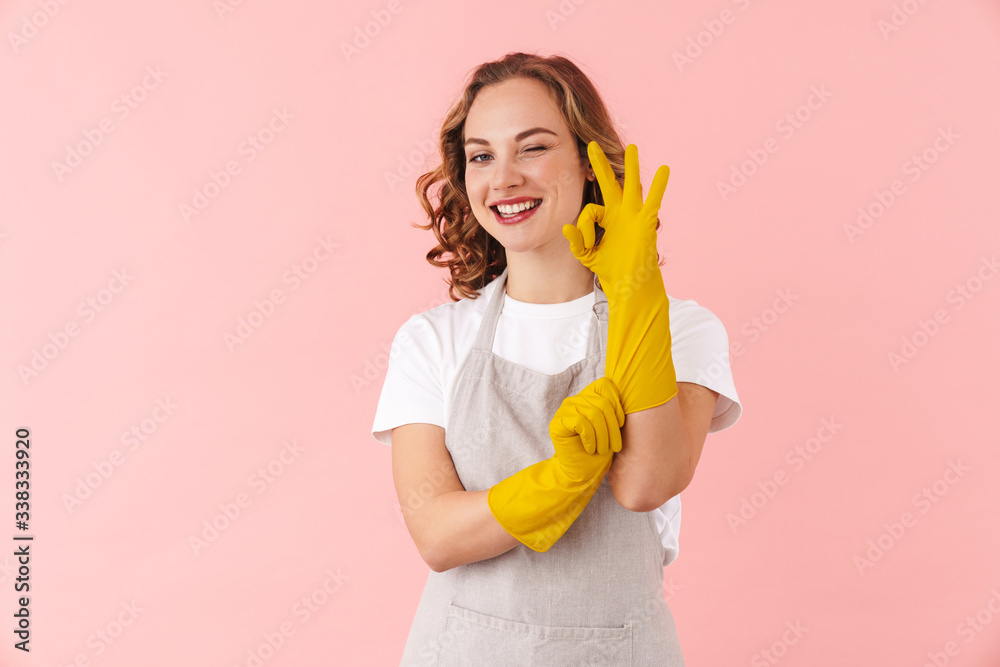 Young woman housewife in gloves showing okay gesture. Young woman housewife in gloves showing okay gesture.