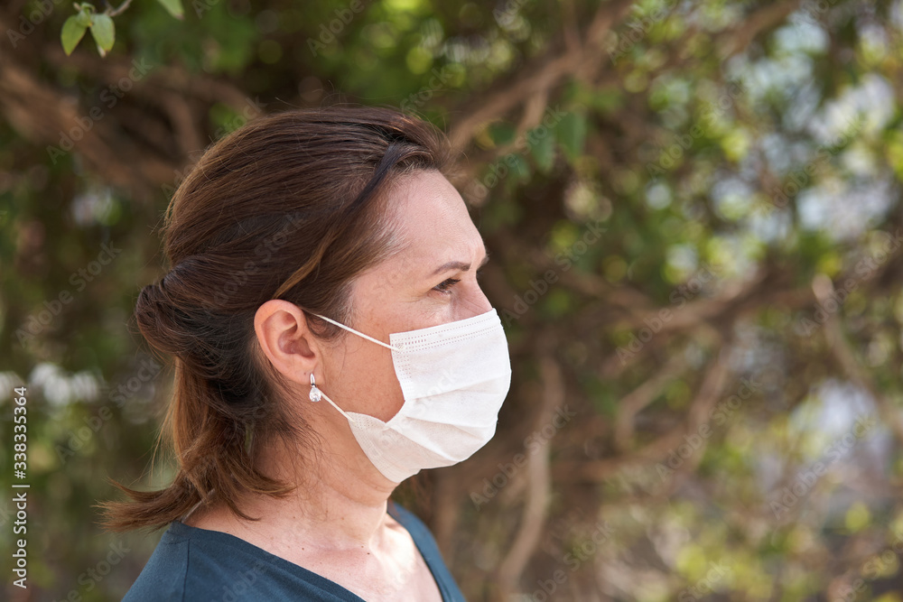 close up portrait of woman wearing surgical mask because of viruses and air pollution. Covid-19. close up portrait of woman wearing surgical mask because of viruses and air pollution. Covid-19.