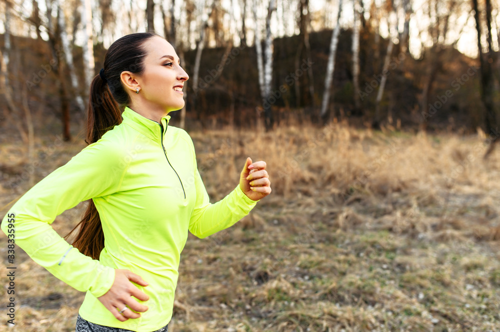 A young fit woman in sportswear is jogging outdoor A young fit woman in sportswear is jogging outdoor