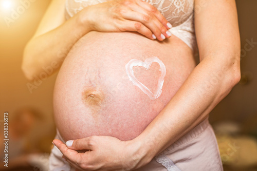 Wallpaper Mural A closeup of a pregnant woman's tummy, with a heart drawn around her belly button. Torontodigital.ca