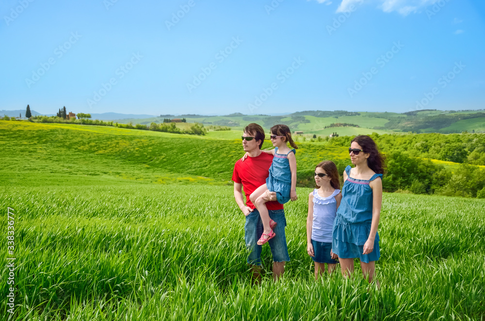 Happy family with children having fun outdoors on green field, spring family vacation with kids in Tuscany, Italy
Happy family with children having fun outdoors on green field, spring family vacation with kids in Tuscany, Italy