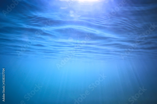 ocean water blue background underwater rays sun / abstract blue background nature water © kichigin19