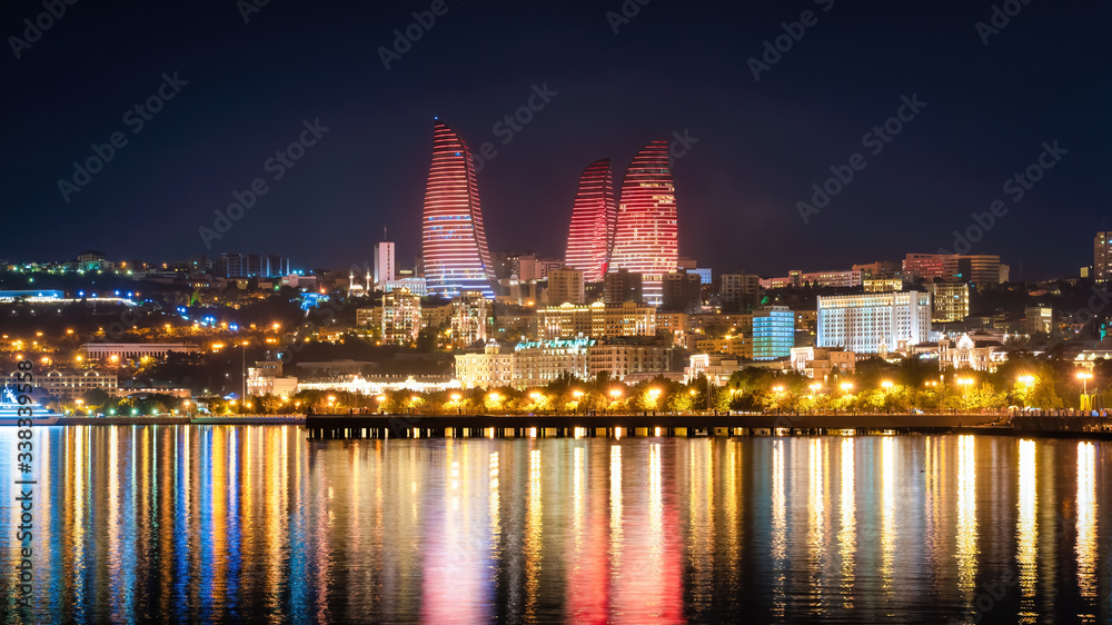 Baku, Azerbaijan - July 2019: Flame Towers in night cityscape. The facades of Flame Towers function as large display screens with the use of more than 10,000 high-power LED luminaires
