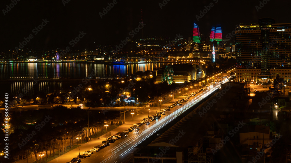 Baku, Azerbaijan - July 2019: Baku cityscape at night with Caspian Sea and Flame Towers Baku, Azerbaijan - July 2019: Baku cityscape at night with Caspian Sea and Flame Towers