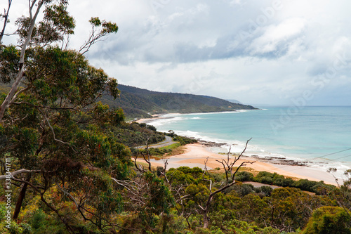 Beach waves and mountain rocks coastline. urquoise ocean sea, white sand, road trip. Travel, driving, road trip, holiday, vacation, journey, paradise. Great Ocean Road. Melbourne, Australia. photo