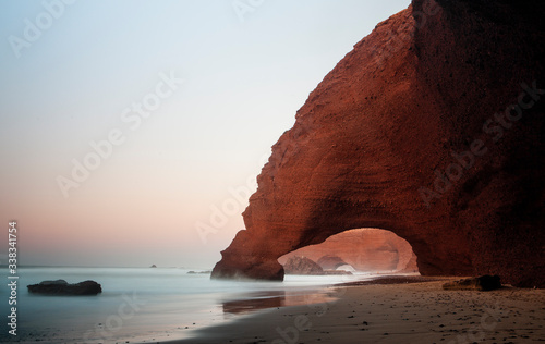 Sunset at red arches of Legzira beach, Sidi Ifni, Souss-Massa-Draa, Morocco