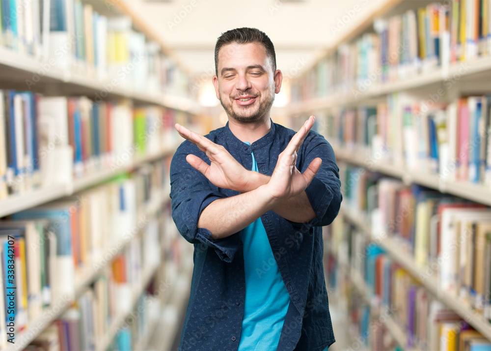 Young man wearing a blue outfit. Crossing arms. Young man wearing a blue outfit. Crossing arms.