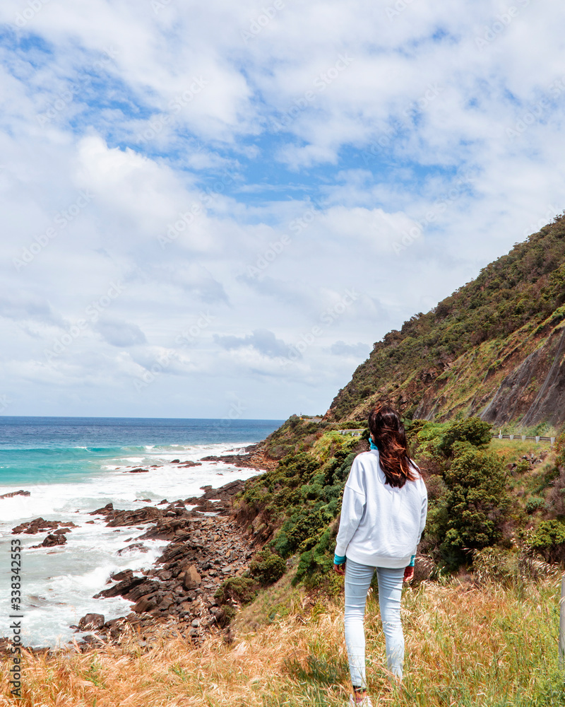 Woman, Beach sea waves and mountain rocks coastline. urquoise ocean, white sand, road trip. Travel, driving, road trip, holiday, vacation, journey, paradise. Great Ocean Road. Melbourne, Australia.