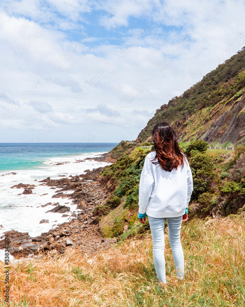 Woman, Beach sea waves and mountain rocks coastline. urquoise ocean, white sand, road trip. Travel, driving, road trip, holiday, vacation, journey, paradise. Great Ocean Road. Melbourne, Australia.