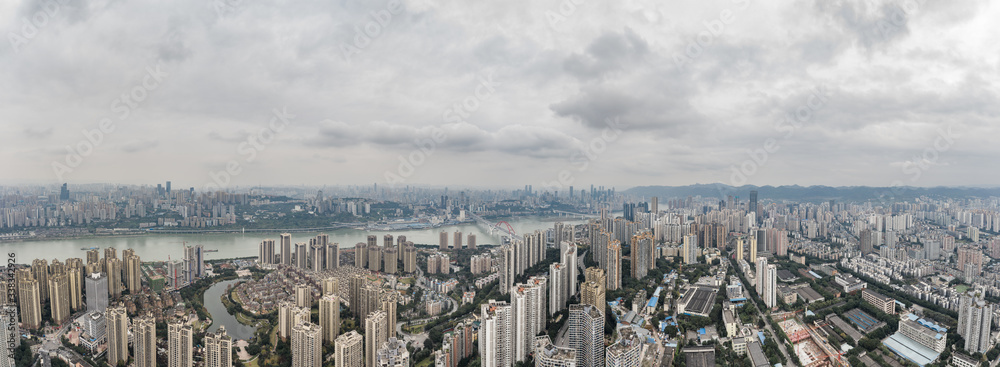 Fototapeta premium Aerial pano pano drone shot of populated residence buildings alng Yangtze river in Chongqing, southwest China metropolis