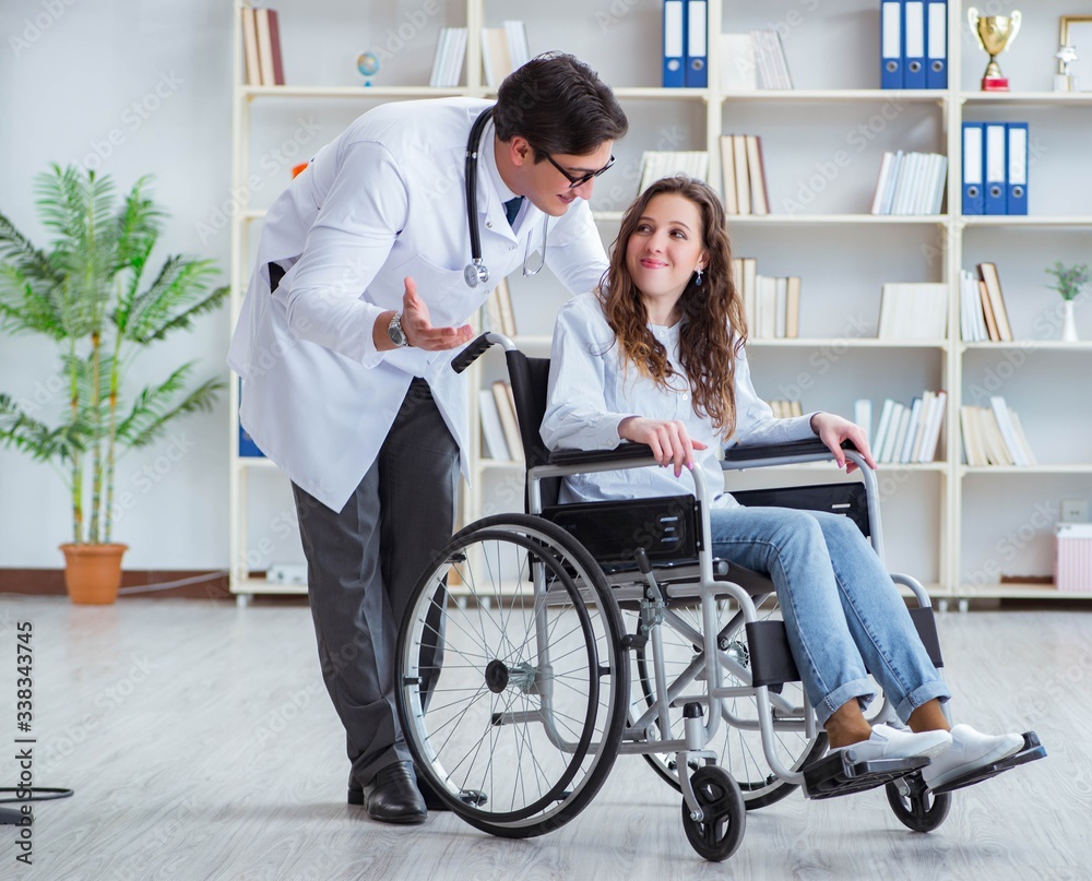 Disabled patient on wheelchair visiting doctor for regular check Disabled patient on wheelchair visiting doctor for regular check