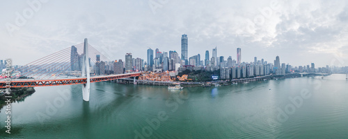 Aerial Pano drone shot of Hong Ya Dong cave by Jialing river with Qiansimen suspension bridge in Chongqing, southwest China