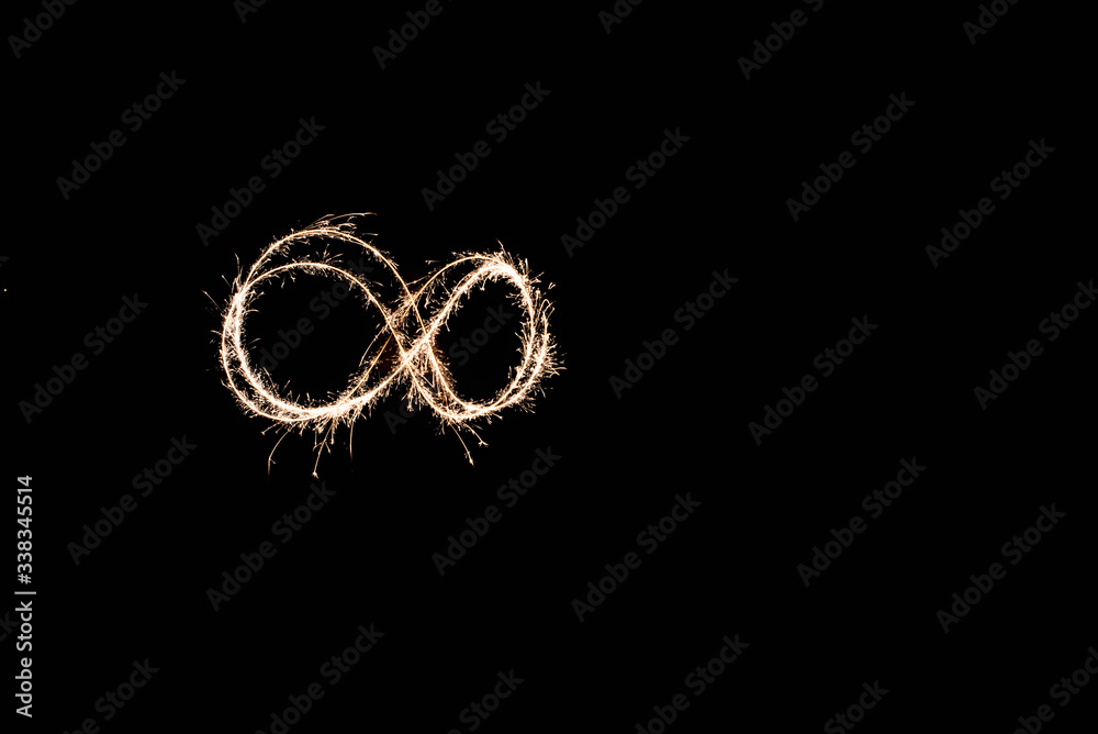 handwritten infinite loop, light painting experiment with bulb exposure, at night. black background