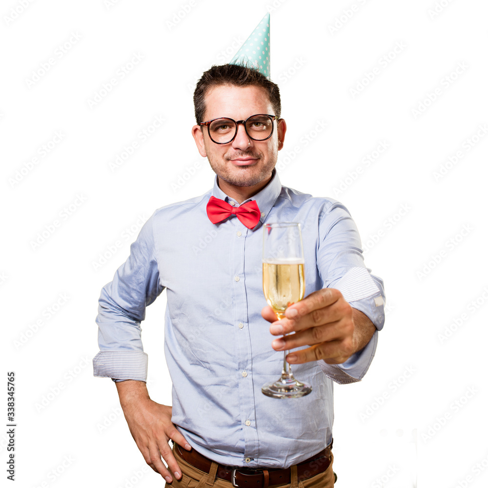 Man wearing a red bow tie and party hat. Offering a champagne glass. Man wearing a red bow tie and party hat. Offering a champagne glass.
