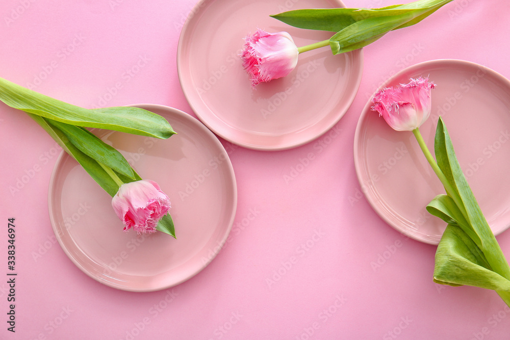 Clean plates and flowers on color background Clean plates and flowers on color background