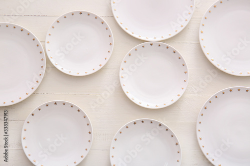 Clean plates on white wooden background