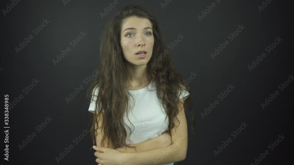 pretty girl fixes long loose curly hair and crosses hands pretty girl fixes long loose curly hair and crosses hands