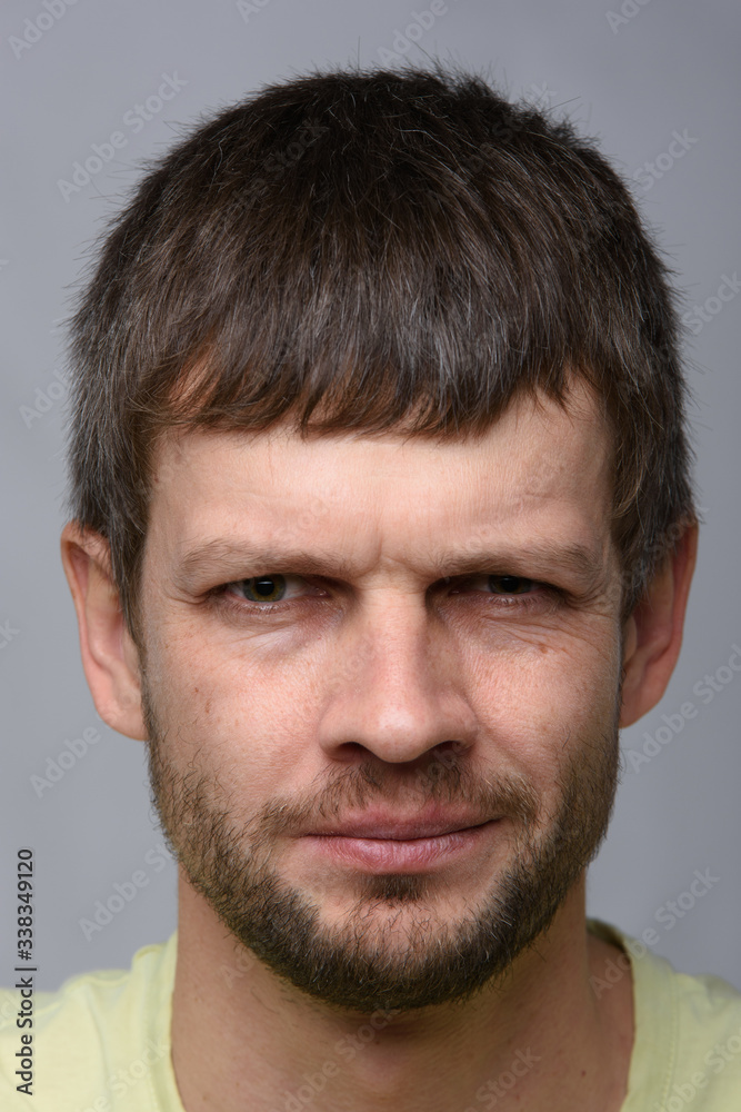 Close-up portrait of a suspicious man of European appearance Close-up portrait of a suspicious man of European appearance