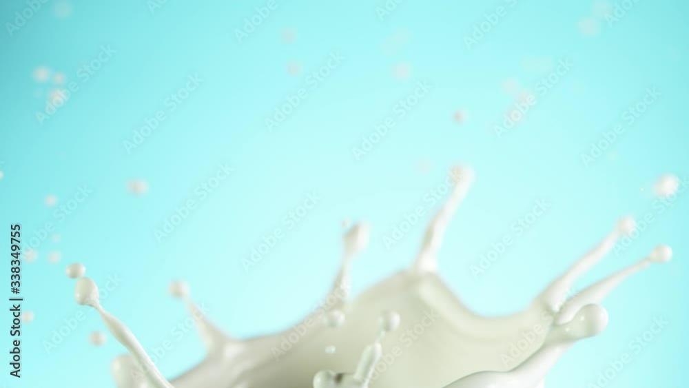 Super slow motion of milk splash isolated on soft blue background. Filmed on high speed cinema camera, 1000 fps. Super slow motion of milk splash isolated on soft blue background. Filmed on high speed cinema camera, 1000 fps.